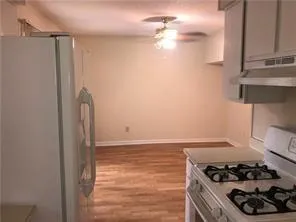 a kitchen with a refrigerator stove and a sink