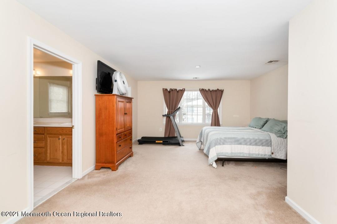 298 Spring Street Red Bank, NJ 07701 - Photo 13 of 17 a bedroom with a bed and a walk in closet with window