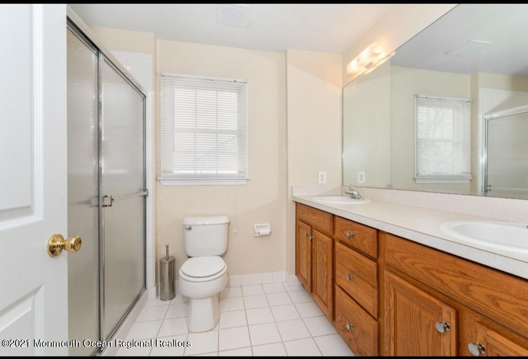 298 Spring Street Red Bank, NJ 07701 - Photo 14 of 17 a spacious bathroom with a granite countertop sink a toilet and a shower