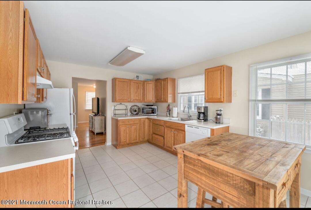 298 Spring Street Red Bank, NJ 07701 - Photo 7 of 17 a kitchen with stainless steel appliances kitchen island granite countertop a sink counter space and a window