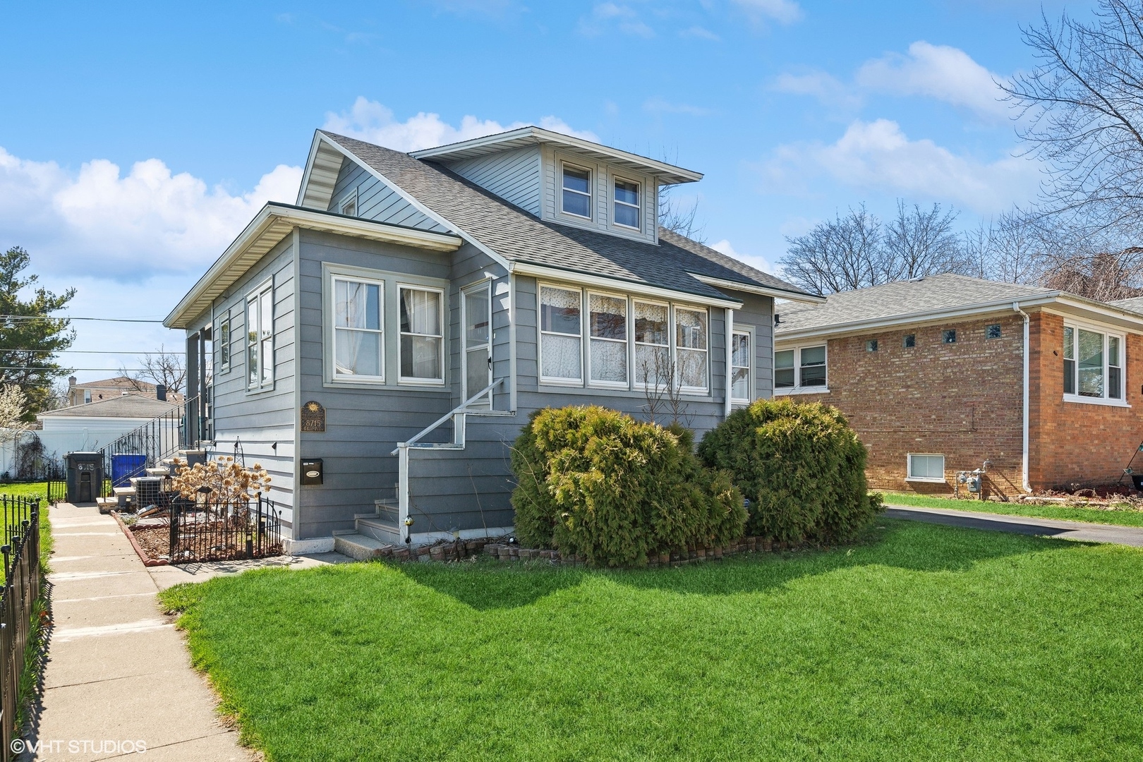 a front view of a house with a garden