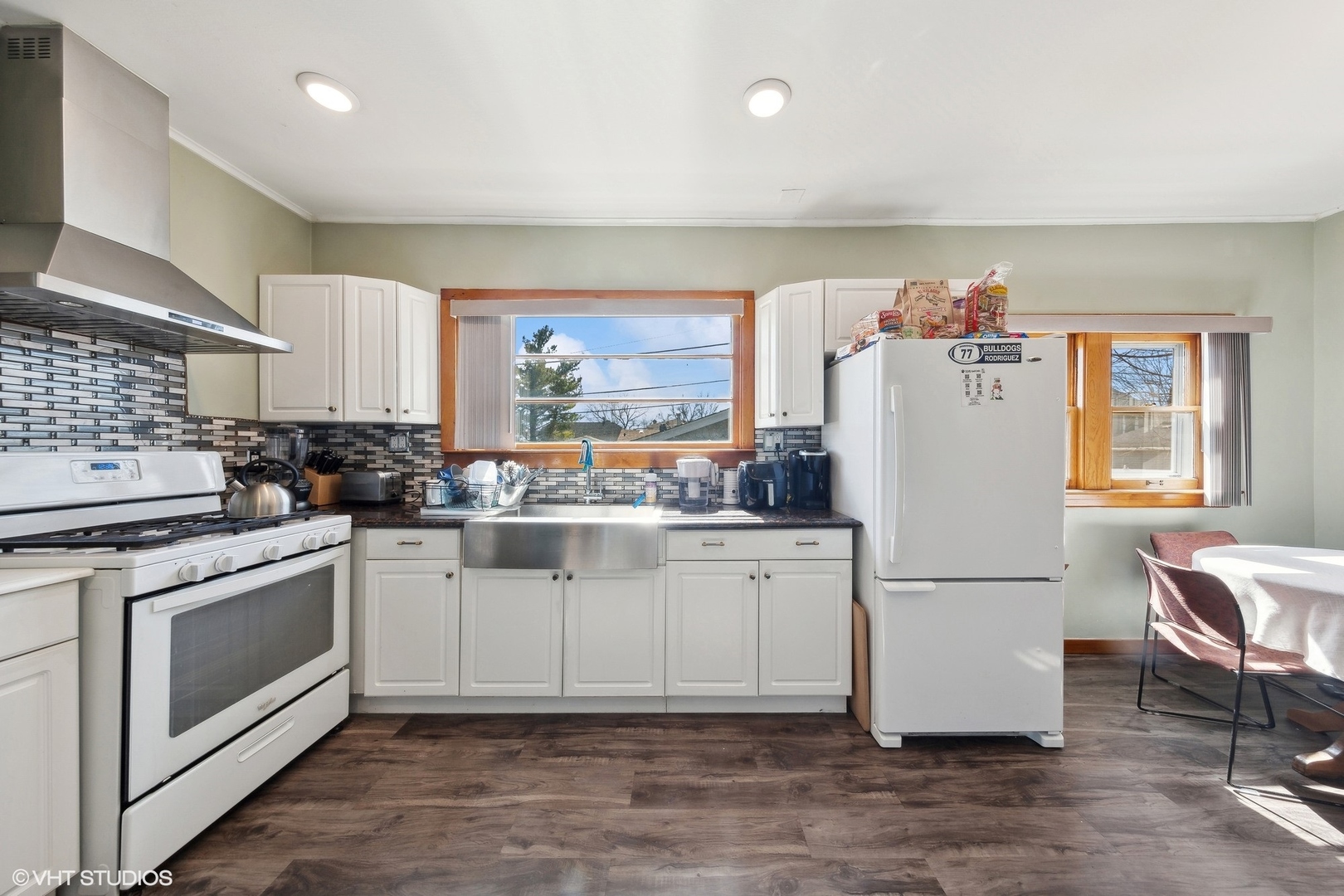 8715 44th Place Lyons, IL 60534 - Photo 5 of 28 a kitchen with a refrigerator and white cabinets