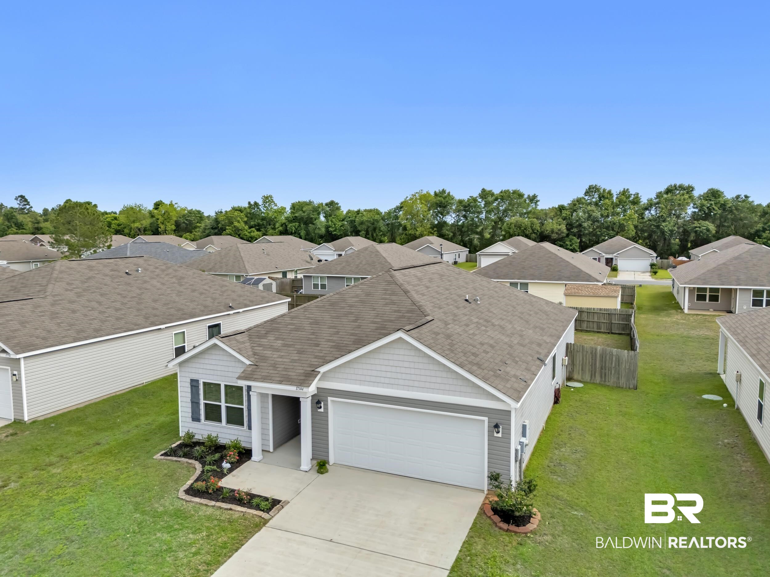 17344 Harding Drive Foley, AL 36535 - Photo 40 of 46 Contemporary single-story residence with light gray siding and a dark gray shingle roof