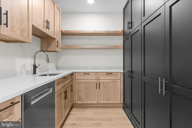 a kitchen with a sink and cabinets