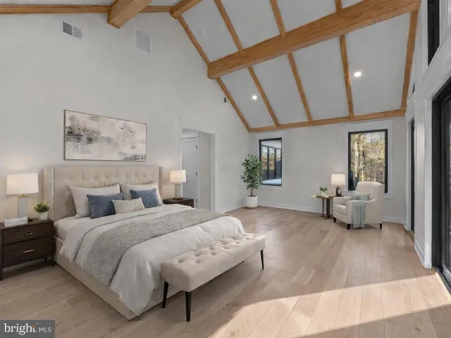 a spacious bedroom with a bed and a couch