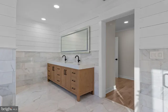 a bathroom with a double vanity sink and a mirror