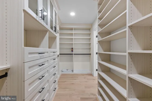a view of walk in closet with empty racks