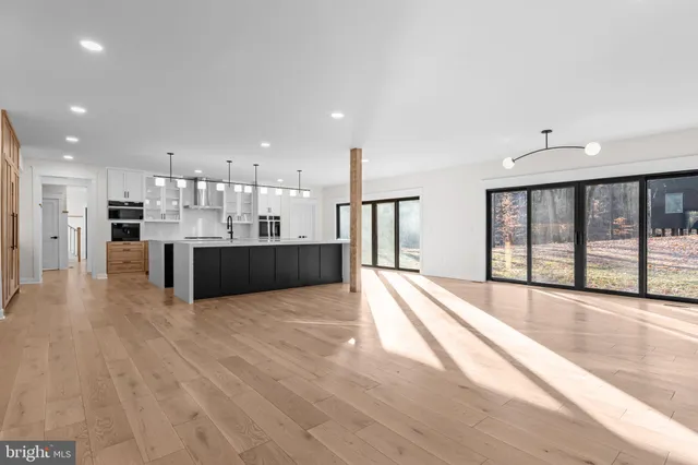 a view of large kitchen with large windows and a chandelier