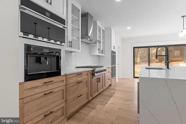 a kitchen with stainless steel appliances granite countertop a stove and a microwave