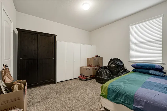 a bedroom with bed and window