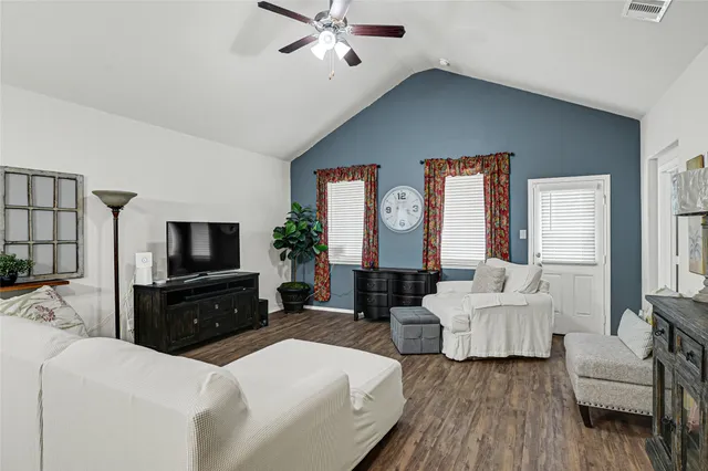 a living room with fireplace furniture and a flat screen tv