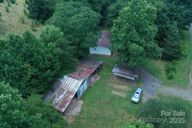 an aerial view of a house with backyard space and garden