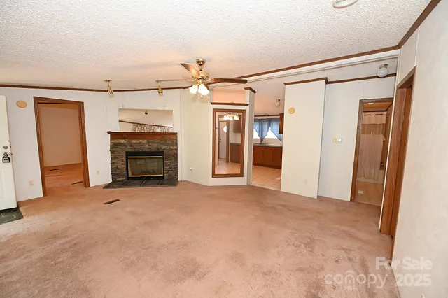 a view of empty room with a fireplace
