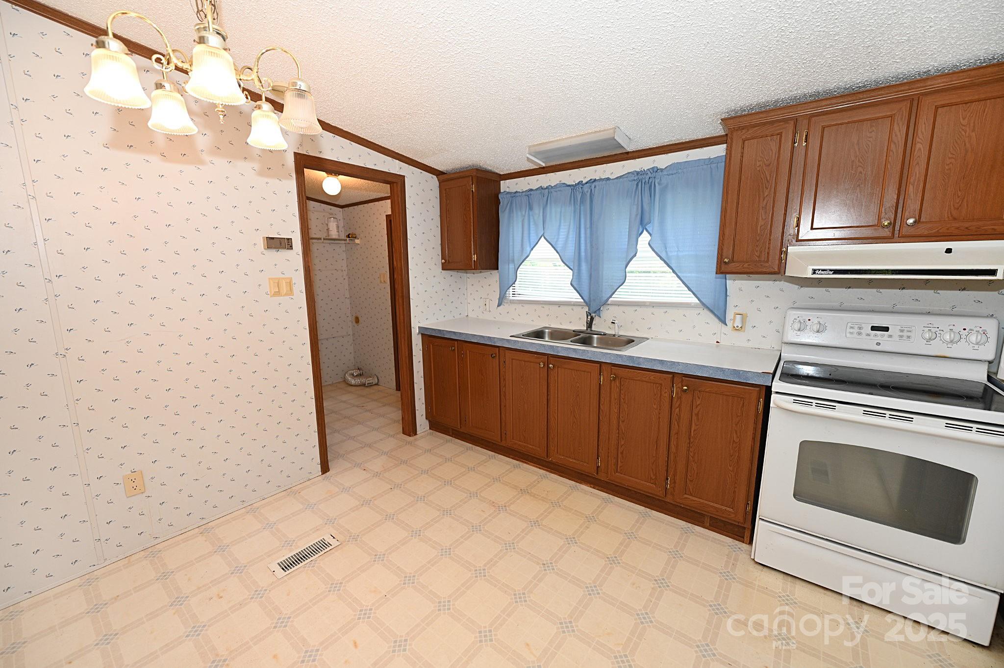 4171 Leatherman Road Vale, NC 28168 - Photo 18 of 24 a kitchen with stainless steel appliances granite countertop a sink stove and refrigerator