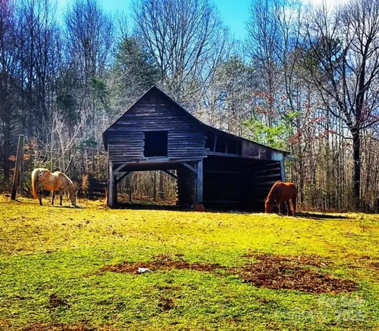 a view of swimming pool with table and chairs under an umbrella