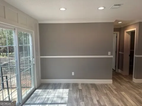 a view of walk in closet with hardwood floor