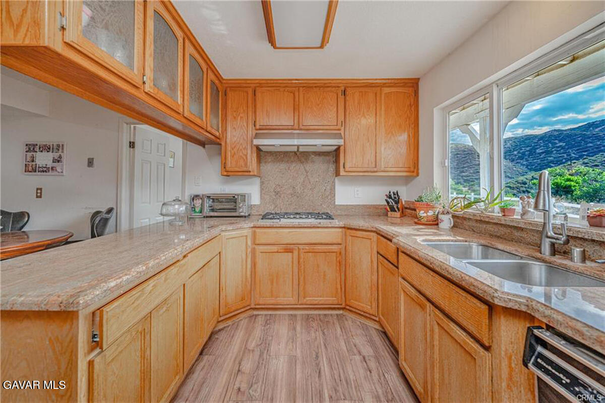 43155 Lake Hughes Road Lake Hughes, CA 93532 - Photo 15 of 37 a kitchen that has a sink and a stove