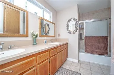 a bathroom with a granite countertop sink a mirror and a bathtub