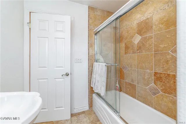 a bathroom with a bathtub and shower