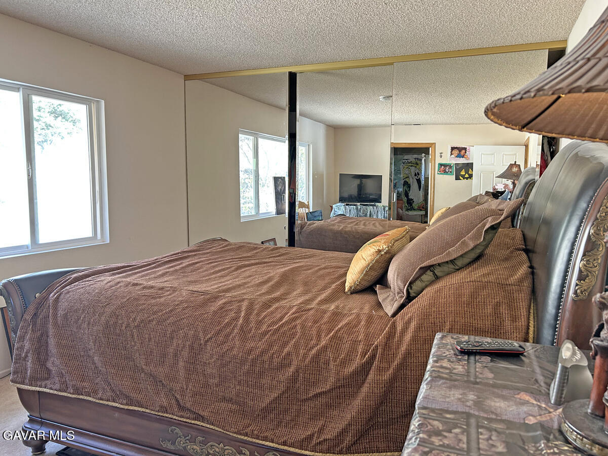 43155 Lake Hughes Road Lake Hughes, CA 93532 - Photo 23 of 37 a bedroom with a bed and window