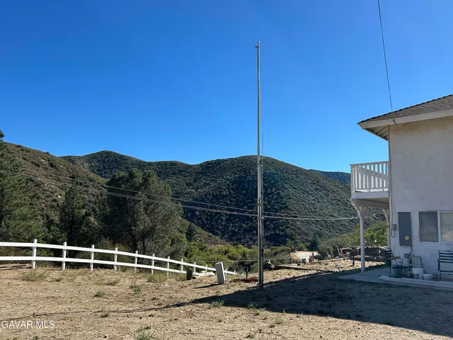 a view of a roof deck with table and chairs