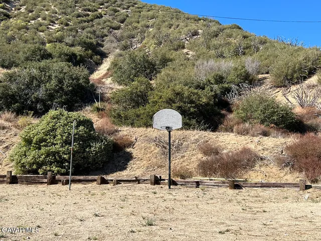 a backyard of a house with large trees