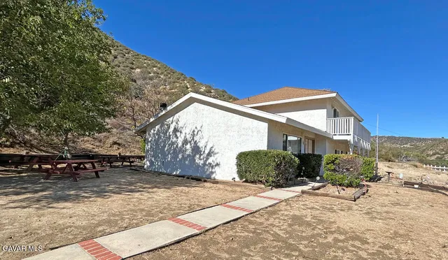 a view of a house with a snow in the background