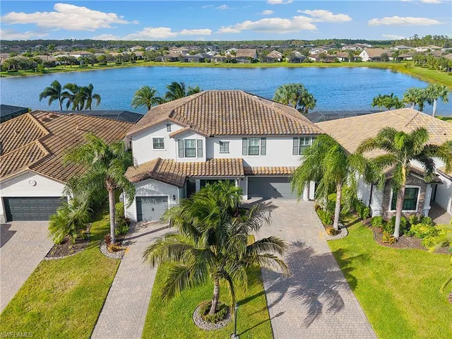 an aerial view of residential houses with outdoor space and swimming pool