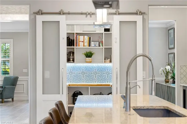a utility room with stainless steel appliances and cabinets