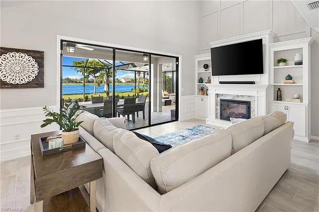 a living room with furniture and a dining table with kitchen view