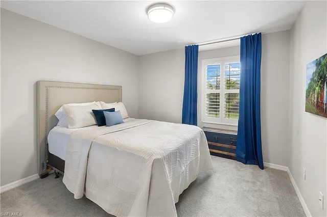 a en suite bathroom with a granite countertop sink and a mirror