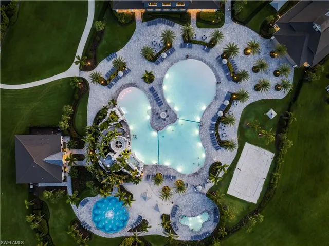 a room with lots of tables a large window and chairs