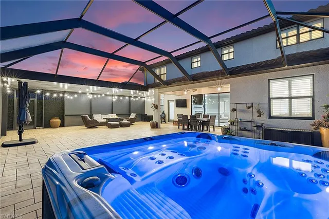 a view of swimming pool with a table and chairs under an umbrella