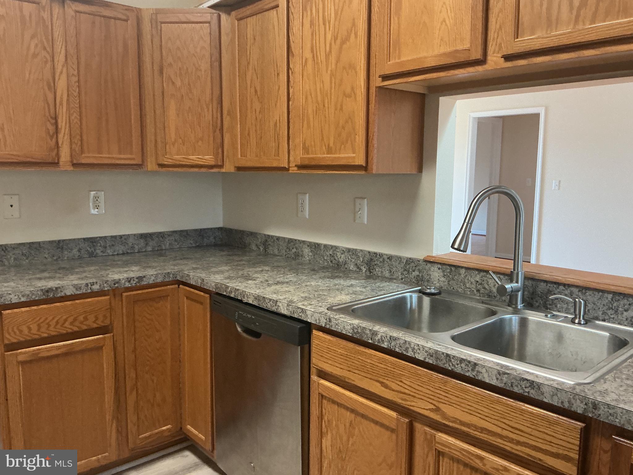 205 Freedom Road Locust Grove, VA 22508 - Photo 11 of 29 a kitchen with granite countertop a sink a stove and cabinets