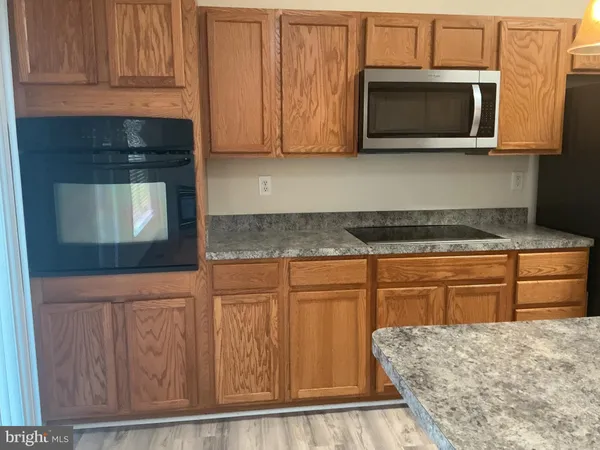 an empty room with wooden floor and closet area