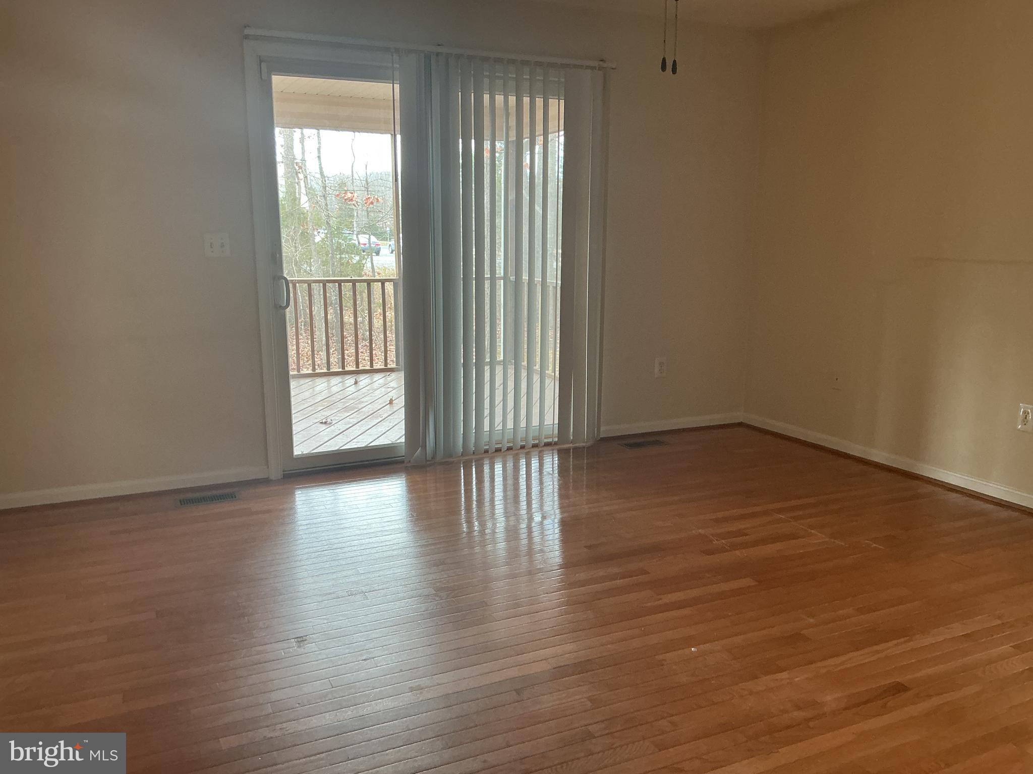 205 Freedom Road Locust Grove, VA 22508 - Photo 19 of 29 a view of an empty room with wooden floor and a window