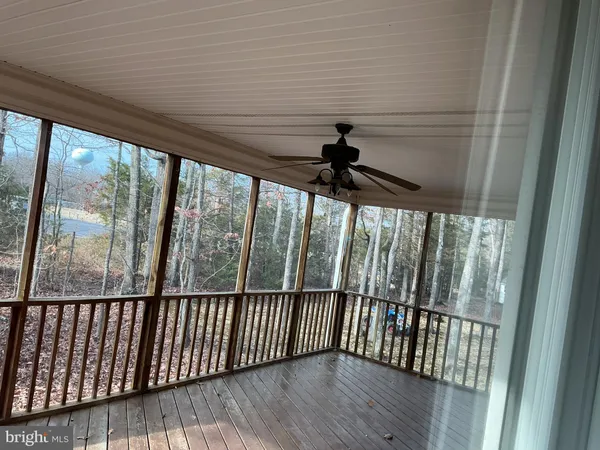 a view of balcony with wooden floor and fence