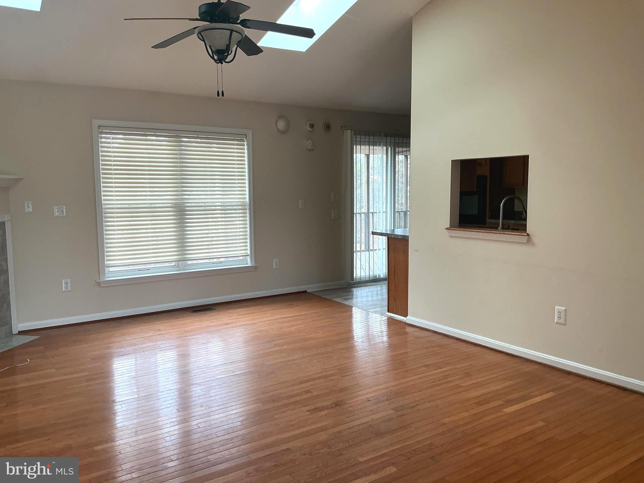 205 Freedom Road Locust Grove, VA 22508 - Photo 6 of 29 an empty room with wooden floor fan and windows