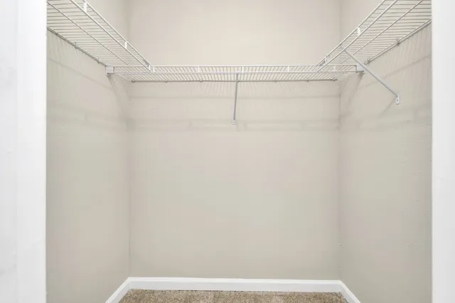 a view of hallway with furniture and a gate