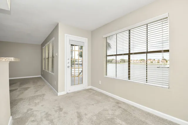 a view of kitchen with cabinets and refrigerator