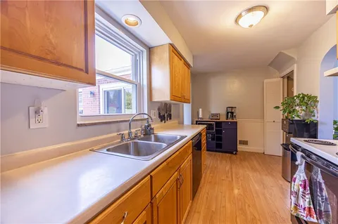 a kitchen with sink a counter space and a window