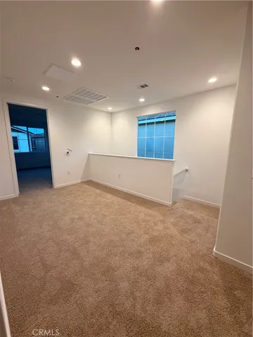 an empty room with a natural light and window