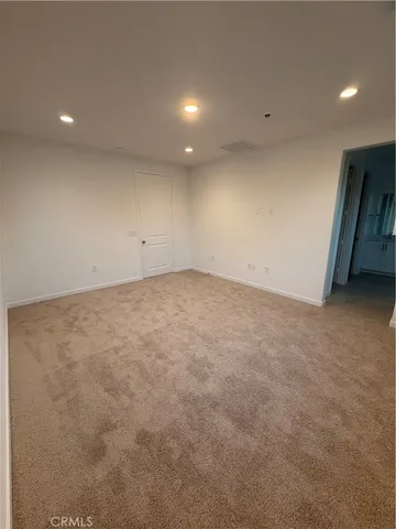 a large room with a lot of cabinets and wooden floor