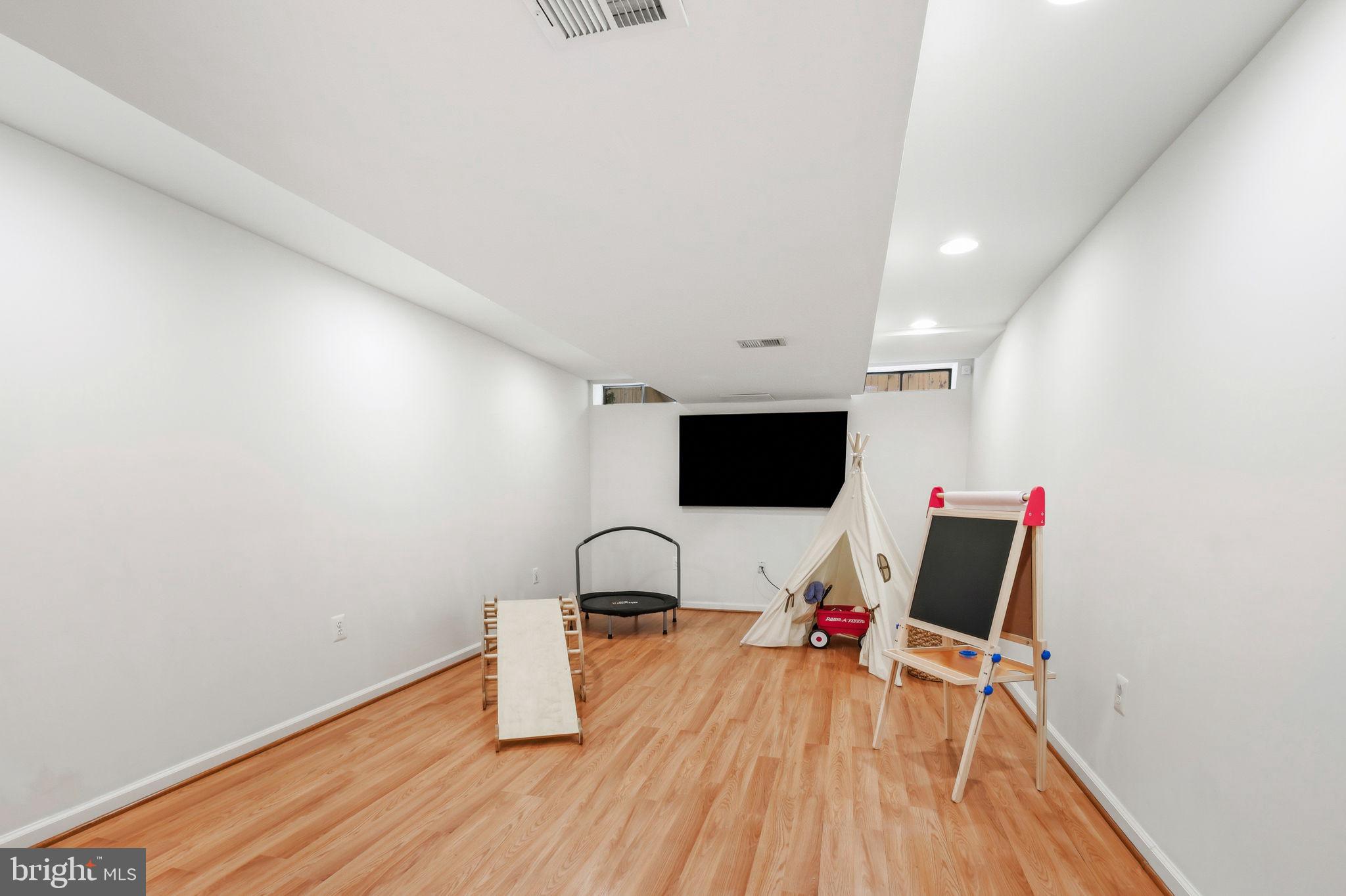10900 Gainsborough Road Potomac, MD 20854 - Photo 35 of 44 a living room with furniture and a flat screen tv