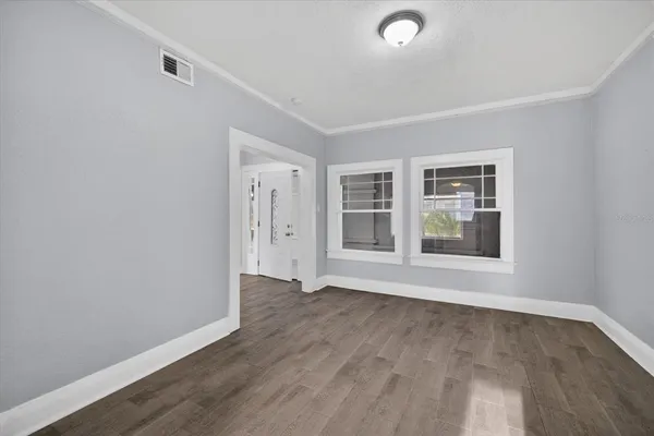 wooden floor in an empty room with a window