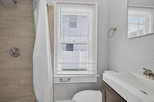 a view of a hallway with a room and a cabinet