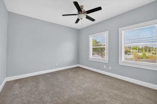 a view of a chair and table in front of house