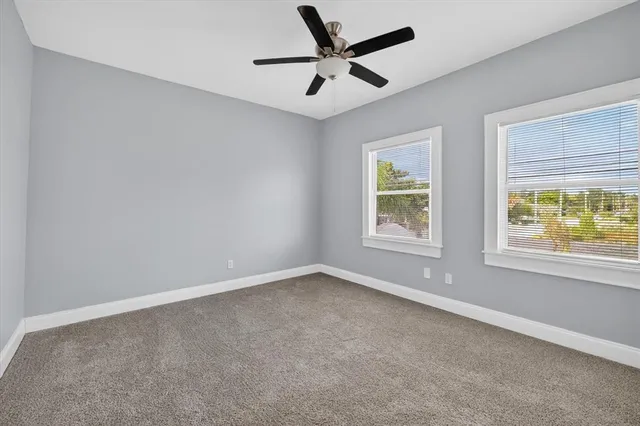 a view of a chair and table in front of house