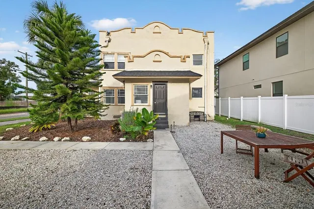 a view of a backyard with sitting area