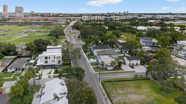 an aerial view of residential houses with outdoor space and swimming pool